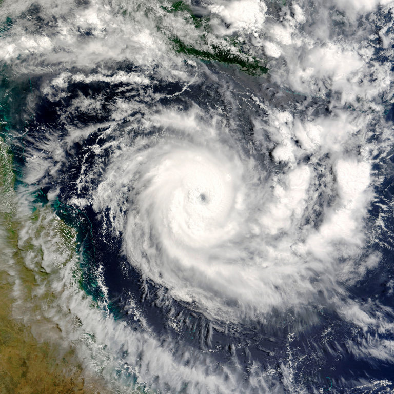 An image of a powerful hurricane over the ocean, illustrating the impact of climate change on weather patterns that can disrupt sporting events and outdoor activities.
