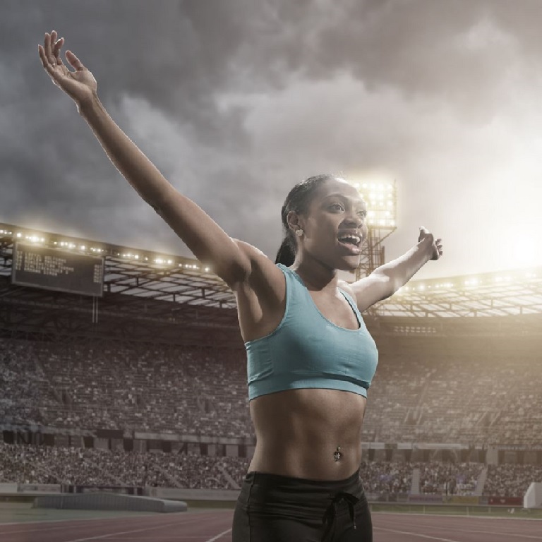 Olympic athlete celebrates in a full stadium